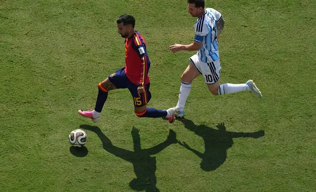 Spain's Victor Munoz (25) in action in front of Argentina's Lionel Messi (10) during the World Cup final soccer match between Spain and Argentina in East Rutherford, N.J., near New York, Sunday, July 19, 2026. (AP Photo/Matt Rourke)