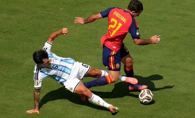 Argentina's Lisandro Martinez (6) fouls Spain's Mikel Oyarzabal (21) during the World Cup final soccer match between Spain and Argentina in East Rutherford, N.J., near New York, Sunday, July 19, 2026. (AP Photo/Seth Wenig)