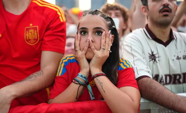 Spanish fans react while watching the World Cup final soccer match between Spain and Argentina on giant screens in Barcelona, Sunday, July 19, 2026. The match is being played in East Rutherford, N.J., near New York. (AP Photo/Joan Mateu Parra)