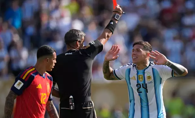 Referee Slavko Vincic, of Slovenia, shows a red card to Argentina's Enzo Fernandez (24) during the World Cup final soccer match between Spain and Argentina in East Rutherford, N.J., near New York, Sunday, July 19, 2026. (AP Photo/Frank Franklin II)