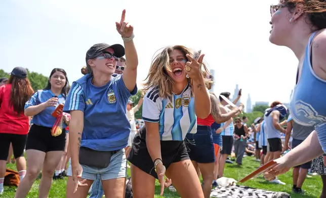 From left, Martina Demaio, Ornella Senarega and Clara Lenger dance during a watch party in Central Park ahead of the World Cup final soccer match between Argentina and Spain, Sunday, July 19, 2026, in New York.(AP Photo/Anna Connors)