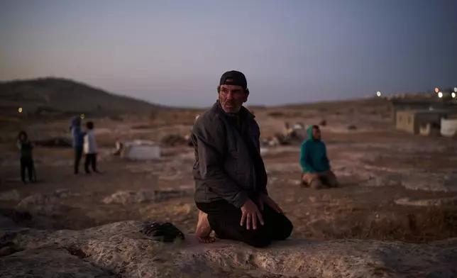 Thalib prays along with other Palestinian men at dusk in their community near the West Bank village of Susya, in the Masafer Yatta region, Wednesday, June 17, 2026.(AP Photo/Leo Correa)