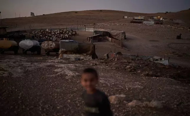 An Israeli settler outpost, top right, overlooks a Palestinian compound at dusk in the northern Jordan Valley in the occupied West Bank, Tuesday, June 23, 2026. (AP Photo/Leo Correa)