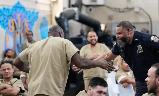Rikers Island inmate Ralph Veal celebrates an English goal with a corrections officer during the World Cup semifinal soccer match between England and Argentina, at the jail complex in New York, Wednesday, July 15, 2026. (AP Photo/Seth Wenig)