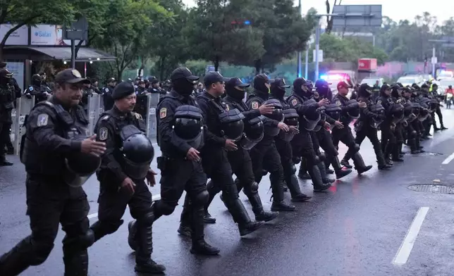 Police officers deploy outside the hotel where the England team will stay in Mexico City ahead of England's World Cup round of 16 soccer match against Mexico, Friday, July 3, 2026. (AP Photo/Eduardo Verdugo)