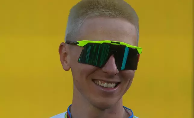 Slovenia's Tadej Pogacar poses on the podium during the team presentation two days ahead of the start of the Tour de France Cycling race in Barcelona, Spain, Thursday, July 2, 2026. (AP Photo/Thibault Camus)