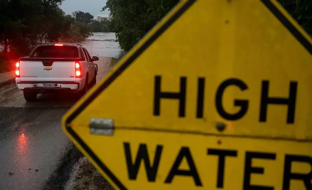 The Pedernales River floods near Old Kerr Highway on Thursday, July 16, 2026, in Fredericksburg, Texas. (AP Photo/Joel Angel Juarez)