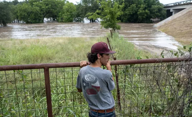 Hugh Ghormley watches as water moves along the Pedernales River at the Blanco County Fair and Rodeo on Thursday, July 16, 2026, in Johnson City, Texas. (AP Photo/Joel Angel Juarez)