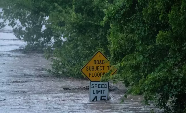 The Pedernales River floods along State Highway 16 on Thursday, July 16, 2026, in Fredericksburg, Texas. (AP Photo/Joel Angel Juarez)