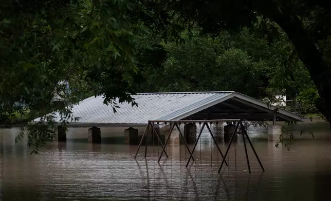 Water along the Pedernales River floods the Gillespie County Safety Rest Area on Thursday, July 16, 2026, in Stonewall, Texas. (AP Photo/Joel Angel Juarez)