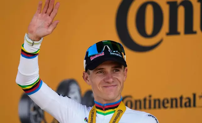 Belgium's Remco Evenepoel arrives on the podium after winning the sixteenth stage of the Tour de France cycling race, an indivdual time-trial with start in Evian-Les-Bains and finish in Thonon-les-Bains, France, Tuesday, July 21, 2026. (AP Photo/Mosa'ab Elshamy)