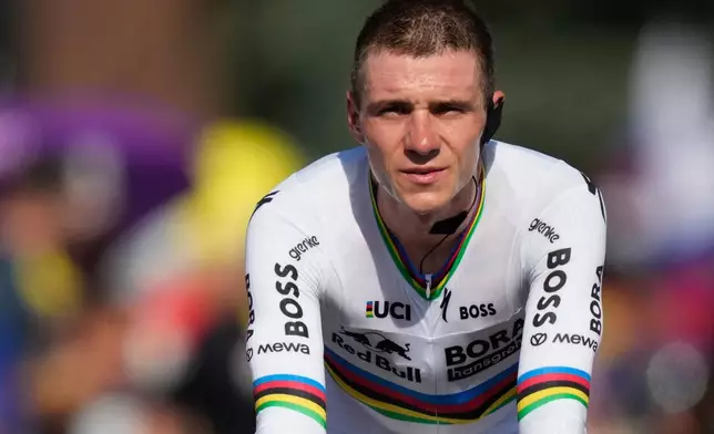 Belgium's Remco Evenepoel rides to the podium after the sixteenth stage of the Tour de France cycling race, an indivdual time-trial with start in Evian-Les-Bains and finish in Thonon-les-Bains, France, Tuesday, July 21, 2026. (AP Photo/Mosa'ab Elshamy)