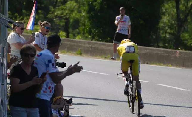 Slovenia's Tadej Pogacar, wearing the overall leader's yellow jersey, rides during the sixteenth stage of the Tour de France cycling race, an indivdual time-trial with start in Evian-Les-Bains and finish in Thonon-les-Bains, France, Tuesday, July 21, 2026. (AP Photo/Thibault Camus)