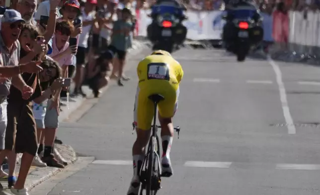 Slovenia's Tadej Pogacar, wearing the overall leader's yellow jersey, rides during the sixteenth stage of the Tour de France cycling race, an indivdual time-trial with start in Evian-Les-Bains and finish in Thonon-les-Bains, France, Tuesday, July 21, 2026. (AP Photo/Thibault Camus)