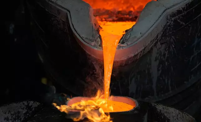 Employees cast bronze bells at the 400-year-old, family-owned Grassmayr bell foundry in Innsbruck, Austria, Friday, July 17, 2026. (AP Photo/Matthias Schrader)