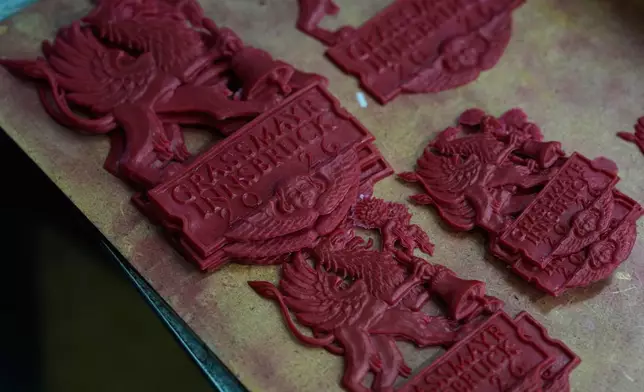 The wax-logo of the 400-year-old family-owned bell foundry Grassmayr lie in the workshop in Innsbruck, Austria, Friday, July 17, 2026. (AP Photo/Matthias Schrader)