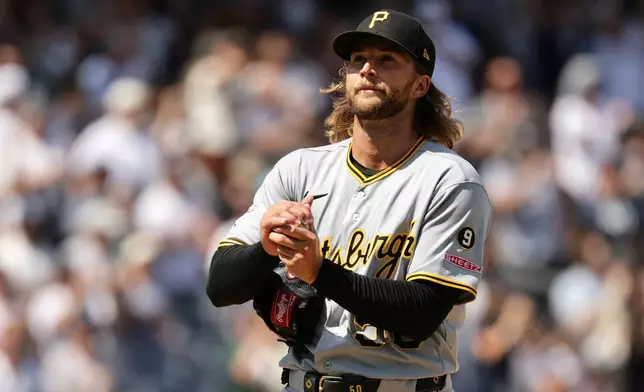 Pittsburgh Pirates pitcher Carmen Mlodzinski reacts after giving up a three-run home run to New York Yankees' Ben Rice in the seventh inning during the first baseball game of a doubleheader, Wednesday, July 22, 2026, in New York. (AP Photo/Adam Hunger)