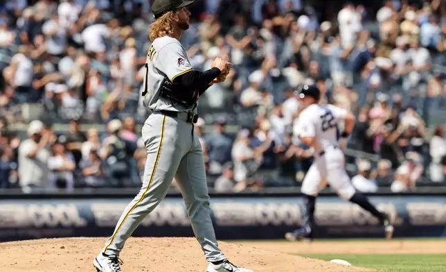 Pittsburgh Pirates pitcher Carmen Mlodzinski reacts after giving up a three-run home run to New York Yankees' Ben Rice in the seventh inning during the first baseball game of a doubleheader, Wednesday, July 22, 2026, in New York. (AP Photo/Adam Hunger)
