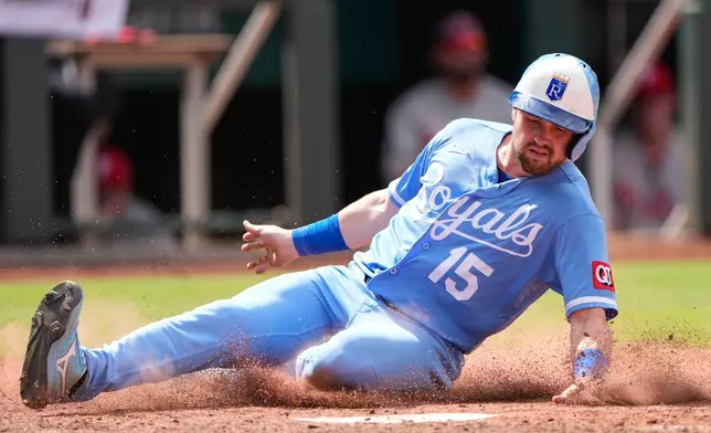 Kansas City Royals' Lane Thomas slides home to score on a two-run double hit by Salvador Perez during the eighth inning of a baseball game against the Philadelphia Phillies, Sunday, July 5, 2026, in Kansas City, Mo. (AP Photo/Charlie Riedel)