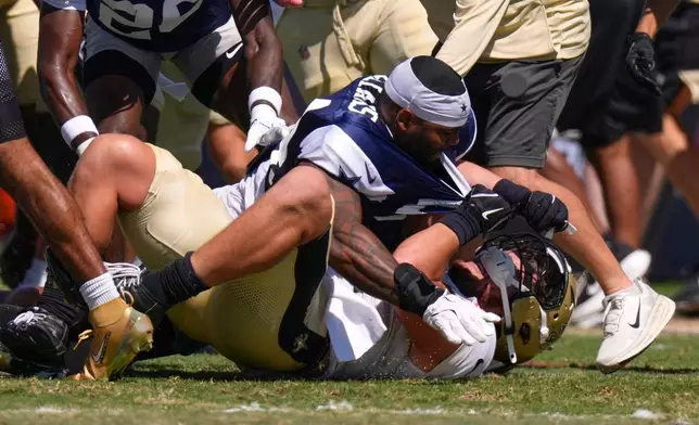 Dallas Cowboys outside linebacker Sam Williams, top, fight with New Orleans Saints tight end Moliki Matavao during an NFL football joint practice, Tuesday, Aug. 18, 2026, in Oxnard, Calif. (AP Photo/Mark J. Terrill)