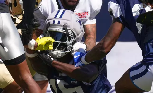 New Orleans Saints wide receiver Ronnie Bell, top, fights with Dallas Cowboys cornerback Derion Kendrick during an NFL football joint practice, Tuesday, Aug. 18, 2026, in Oxnard, Calif. (AP Photo/Mark J. Terrill)