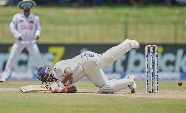 India's Rishabh Pant plays a shot as Sri Lanka's Niroshan Dickwella watches during day two of the second cricket test match between Sri Lanka and India in Colombo, Sri Lanka, Monday, Aug. 24, 2026. (AP Photo/Eranga Jayawardena)