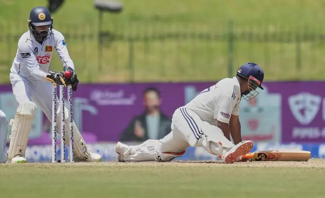 India's Rishabh Pant plays a shot as Sri Lanka's Niroshan Dickwella watches during day two of the second cricket test match between Sri Lanka and India in Colombo, Sri Lanka, Monday, Aug. 24, 2026. (AP Photo/Eranga Jayawardena)