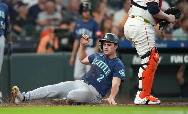 Seattle Mariners' Cole Young scores a run on Brendan Donovan's RBI single during the fourth inning of a baseball game against Houston Astros, Saturday, Aug. 15, 2026, in Houston. (AP Photo/Karen Warren)