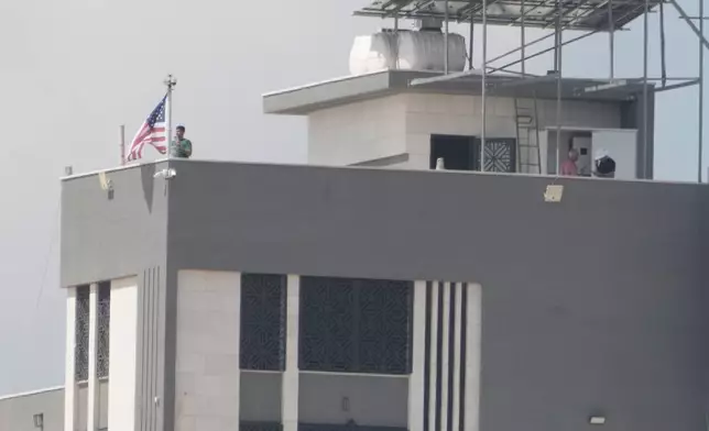 Ohio-based Palestinian-American landlord Loui Ridi, raised the American flag on the roof of his house that is besieged by Israeli settlers for over a week, in the occupied West Bank village of Qusra, south of Nablus, Tuesday, Aug. 18, 2026. (AP Photo/Majdi Mohammed)