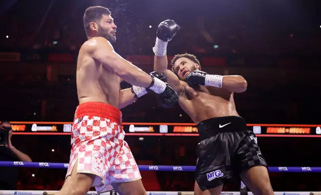 Boxer Moses Itauma, right, punches Filip Hrgovic during their vacant IBF world heavyweight title, Saturday, Aug. 29, 2026, in London. (Steven Paston/PA via AP)