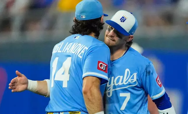 Kansas City Royals' Jac Caglianone (14) and Bobby Witt Jr. (7) celebrate after their baseball game against the Chicago Cubs, Saturday, Aug. 8, 2026, in Kansas City, Mo. (AP Photo/Charlie Riedel)