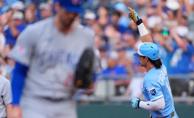 Kansas City Royals' Jac Caglianone, right, celebrates as he runs the bases past Chicago Cubs starting pitcher Clay Holmes, left, after hitting a solo home run during the first inning of a baseball game Saturday, Aug. 8, 2026, in Kansas City, Mo. (AP Photo/Charlie Riedel)