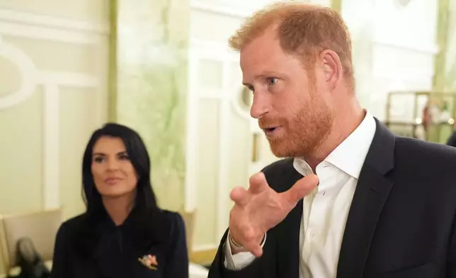 Britain's Prince Harry, the Duke of Sussex, speaks to The Associated Press after a roundtable about support for veterans, Wednesday, Aug. 19, 2026, in Washington, as Sarah Verado, CEO, of The Independence Fund, listens. (AP Photo/Alex Brandon)