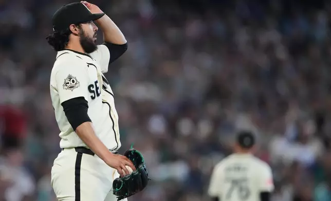 Seattle Mariners relief pitcher Andrés Muñoz reacts after allowing a solo home run from Minnesota Twins' Luke Keaschall to tie the game during the ninth inning of a baseball game, Sunday, Aug. 2, 2026, in Seattle. (AP Photo/Lindsey Wasson)