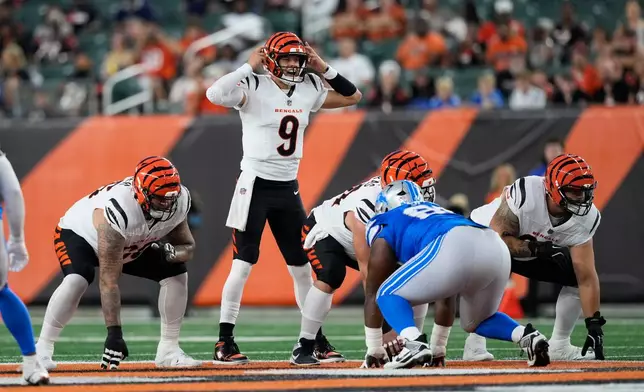 Cincinnati Bengals quarterback Joe Burrow (9) signals at the line of scrimmage against the Detroit Lions during the first half of a preseason NFL football game Thursday, Aug. 13, 2026, in Cincinnati. (AP Photo/Carolyn Kaster))
