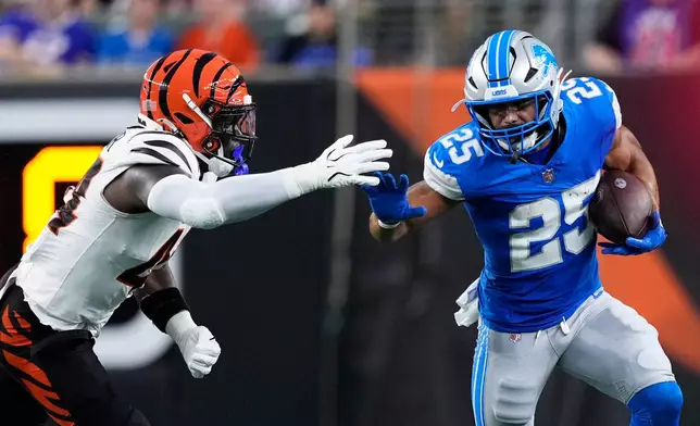 Detroit Lions running back Jacob Saylors (25) tries to get around Cincinnati Bengals linebacker Demetrius Knight Jr. (44) during the first half of a preseason NFL football game Thursday, Aug. 13, 2026, in Cincinnati. (AP Photo/Carolyn Kaster)