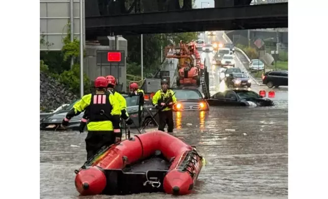 In this photo provided by the City of Jersey City, first responders try to rescue people stranded in Jersey City, N.J., Thursday, Aug. 20, 2026, after storms went through the area. (City of Jersey City via AP)