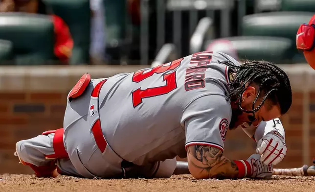Washington Nationals' Andrés Chaparro reacts after getting hit on the helmet by a pitch from Atlanta Braves' JR Ritchie during the fourth inning of a baseball game, Sunday, Aug. 2, 2026, in Atlanta. (AP Photo/Erik S. Lesser)
