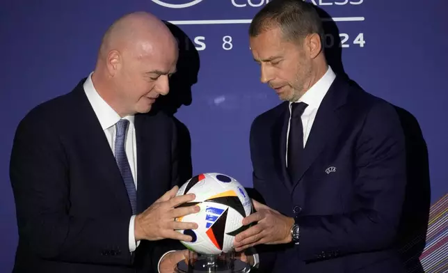 FILE - UEFA President Aleksander Ceferin, right, and FIFA President Gianni Infantino pose during the 48th UEFA congress in Paris, Thursday, Feb. 8, 2024. (AP Photo/Christophe Ena, File)