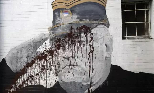 FILE - A mural of former Bosnian Serb military chief Ratko Mladic vandalized with paint in Belgrade, Serbia, Tuesday, Sept. 20, 2022. (AP Photo/Darko Vojinovic, File)