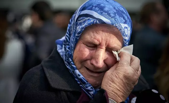 FILE - Nura Mustafic, one of the Mothers of Srebrenica and other Bosnian organizations, wipes away tears as she reacts to the verdict which the Yugoslav War Crimes Tribunal, ICTY, handed down in the genocide trial against former Bosnian Serb military chief Ratko Mladic, in The Hague, Netherlands, Wednesday Nov. 22, 2017. (AP Photo/Phil Nijhuis, File)