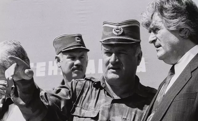 FILE - Bosnian Serb General Ratko Mladic, center, speaks with Bosnian Serb President Radovan Karadzic, right, in the Bosnian town of Banja Luka, in 1994. (AP Photo/Radivoje Pavicic, File)