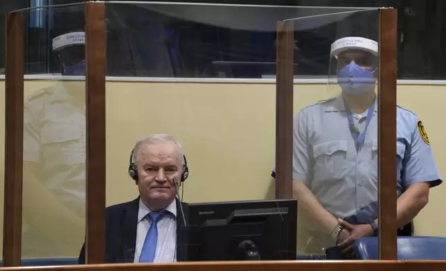 FILE - Former Bosnian Serb military chief Ratko Mladic sits in the court room in The Hague, Netherlands, Tuesday, June 8, 2021, where the United Nations court delivers its verdict in the appeal of Mladic against his convictions for genocide and other crimes and his life sentence for masterminding atrocities throughout the Bosnian war. (AP Photo/Peter Dejong, Pool, File)