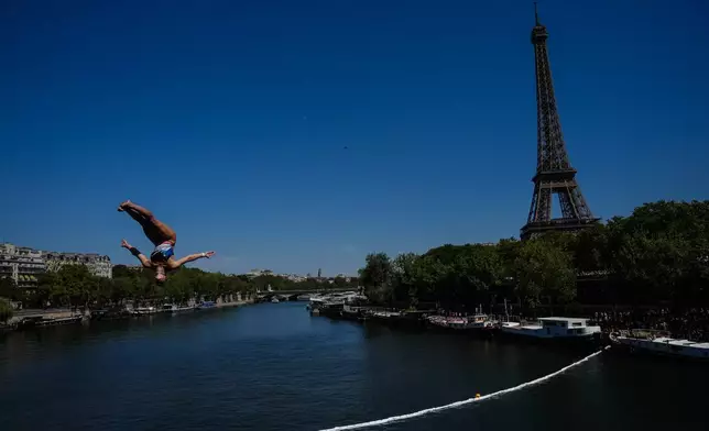 France's Madeleine Bayon competes during round 1 of the Women's 20m Platform as the Eiffel Tower is seen in the background at the European Aquatics Championships in Paris, Friday, Aug. 7, 2026. (AP Photo/Aurelien Morissard)