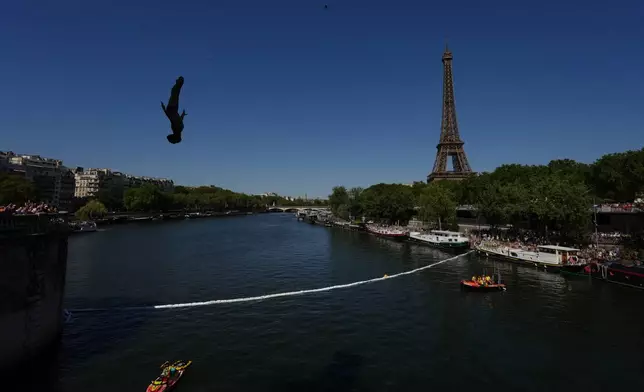 Spain's Carlos Javier Gimeno Martinez competes in front of the Eiffel Tower during round 1 of the men's 20m Platform high diving at the European Aquatics Championships in Paris, Friday, Aug. 7, 2026. (AP Photo/Aurelien Morissard)