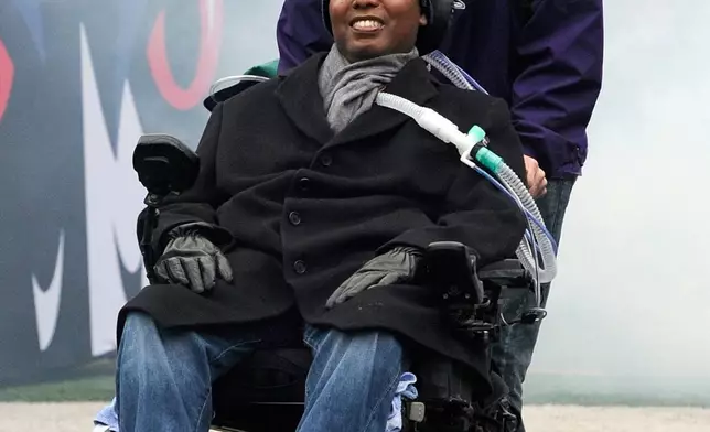 FILE - Former Baltimore Ravens NFL football player O.J. Brigance, front, attends a celebration in Baltimore, Feb. 5, 2013, for the Ravens' Super Bowl victory. (AP Photo/Steve Ruark, File)