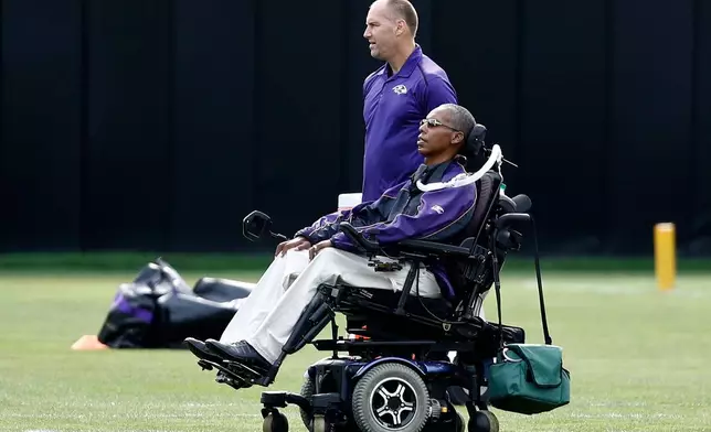 FILE - Baltimore Ravens senior advisor to player engagement O.J. Brigance, bottom, watches an NFL football training camp practice in Owings Mills, Md., Aug. 8, 2017. (AP Photo/Patrick Semansky, File)