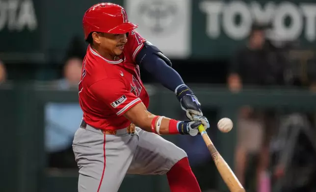 Los Angeles Angels' Gustavo Campero connects for a run-scoring single in the eighth inning of a baseball game against the Texas Rangers Sunday, Aug. 23, 2026, in Arlington, Texas. (AP Photo/Tony Gutierrez)