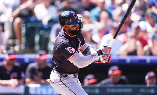 Cleveland Guardians' Jo Adell connects for an RBI single off Colorado Rockies starting pitcher Tomoyuki Sugano in the first inning of a baseball game Sunday, Aug. 23, 2026, in Denver. (AP Photo/David Zalubowski)