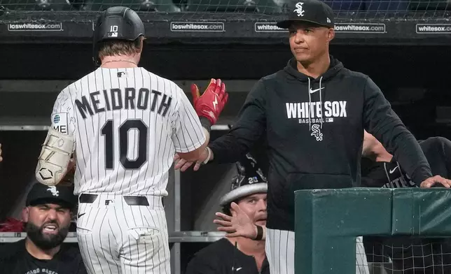 Chicago White Sox's Chase Meidroth, left, is congratulated by manager Will Venable after hitting a two-run home run during the sixth inning of a baseball game against the Cincinnati Reds in Chicago, Wednesday, Aug. 12, 2026. (AP Photo/Nam Y. Huh)